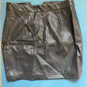Black leather mini skirt with snake pattern. Size S